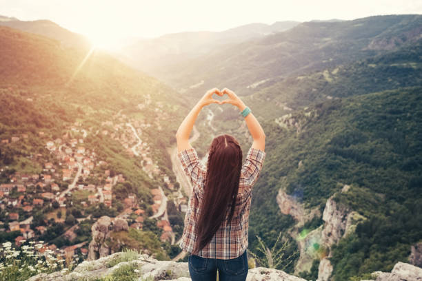 istock Young woman showing heart-shaped symbol 641576240