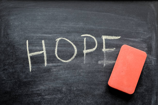 istock erasing hope, hand written word on blackboard being erased concept 641576830
