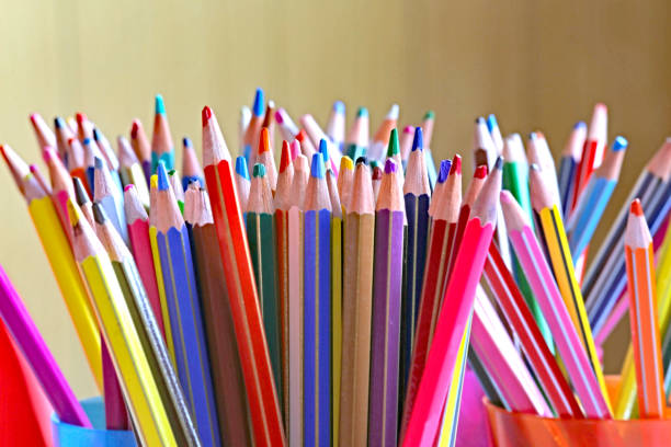 Colored pencil crayons on white isolated ground. School accessories on a white table. White background