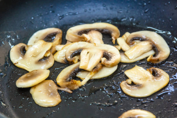 istock Mushrooms sliced and fried in a skillet. 641586908