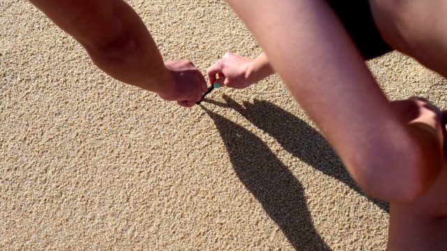 Couple in love draws a heart in the sand