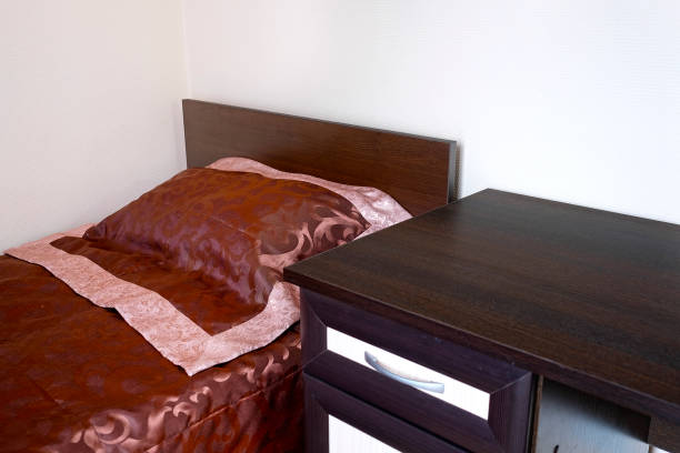 3D Bedroom interior with black bed, lampshade and chair.