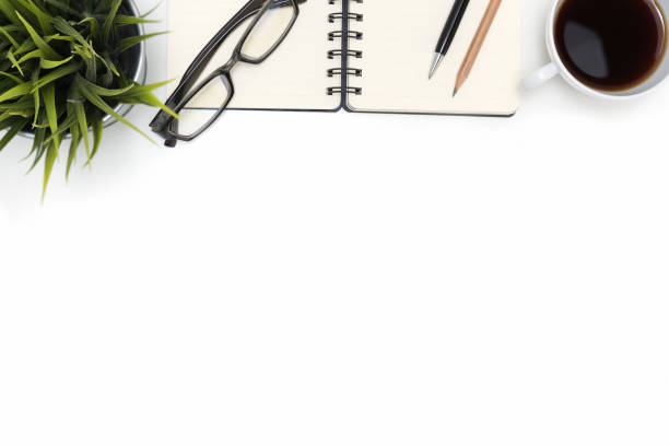 istock Open spiral blank notebook with coffee cup on white desk 641599686