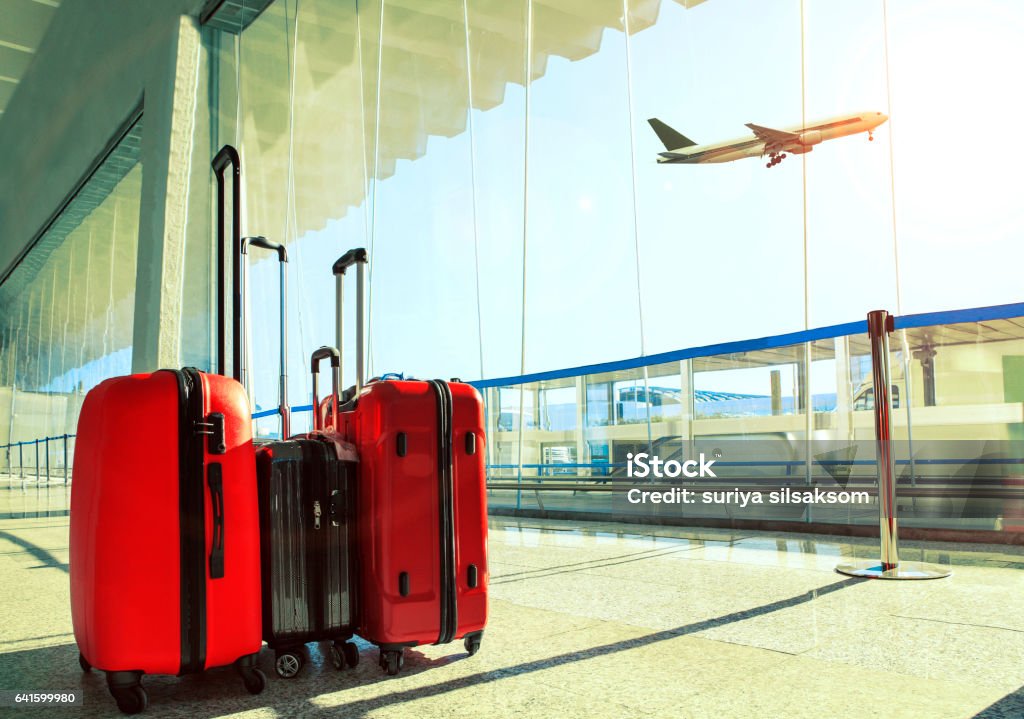 Stapel von Reisen Gepäck im Flughafen-terminal und Passagierflugzeug fliegen über den Himmel - Lizenzfrei Reisegepäck Stock-Foto