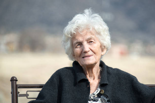 istock Senior women sitting outdoors with nostalgic smile 641600458