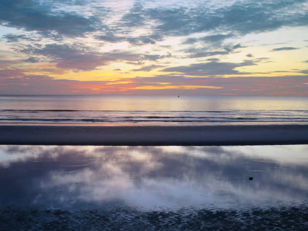 istock reflection of the morning sky on the beach 641602248