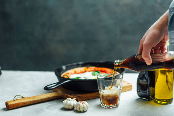 istock Man is pouring cola against homemade pizza 641603204