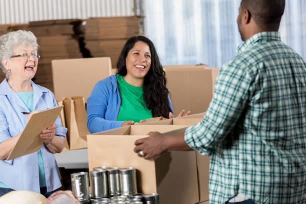 istock Diverse volunteers pack boxes in food bank 641609324