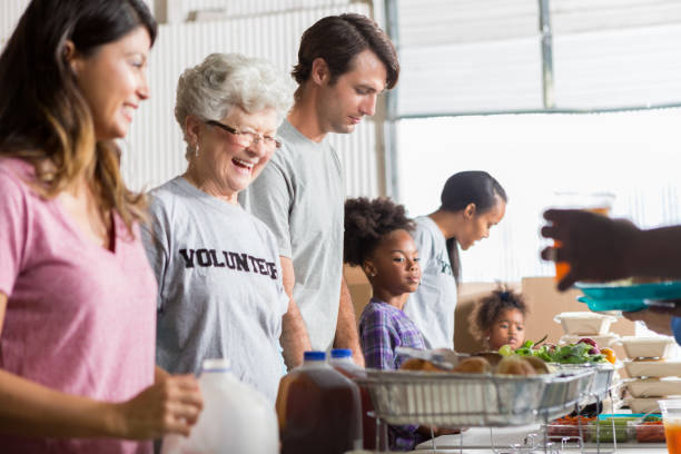 istock Cheerful diverse volunteers work together in soup kitchen 641609328