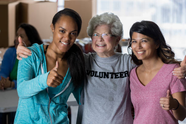 istock Diverse friends give thumbs up while volunteering together 641609346