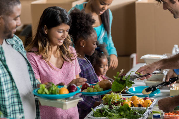 istock Diverse couple receive meal in soup kitchen 641609414