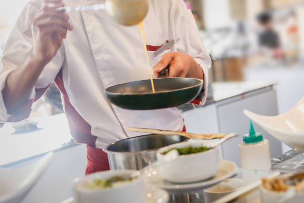 istock Males chef pouring egg from ladle 641611560