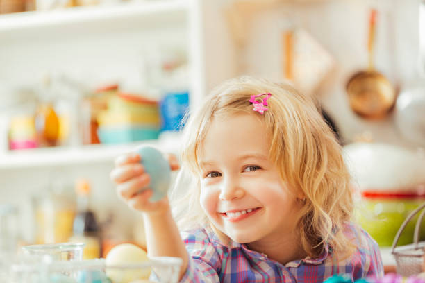 istock Little Girl Holding Natural Dyed Easter Egg 641614108