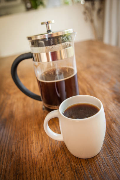 istock White coffee cups and a plunger on a wooden table 641614522