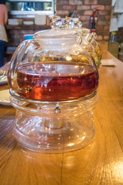 istock Glass tea pot in a cafe on a wooden table 641616680