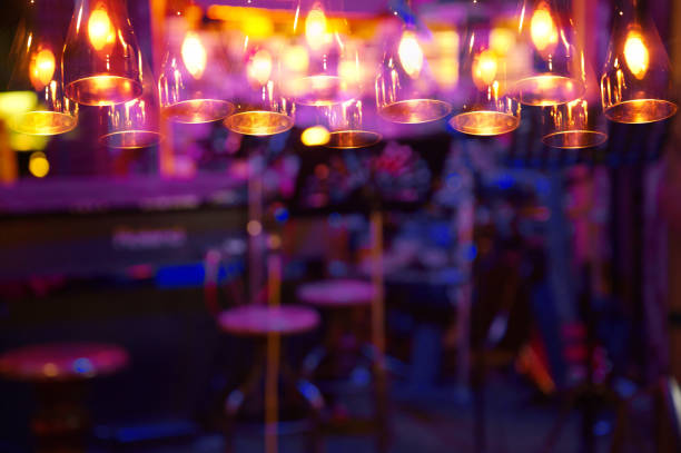 istock blur purple light on bar background with lamp at night 641619502
