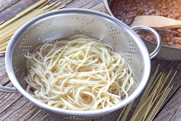 istock Spaghetti  pasta in strainer and bolognese sauce 641619820