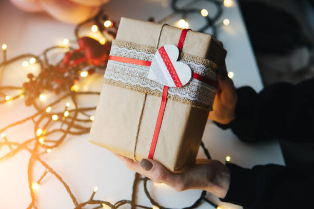 istock girl holding a Christmas gift in hand 641620294
