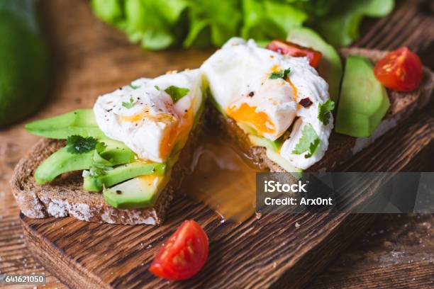 Tasty Sandwich With Poached Egg And Avocado Stock Photo - Download Image Now - Egg - Food, Avocado, Brunch