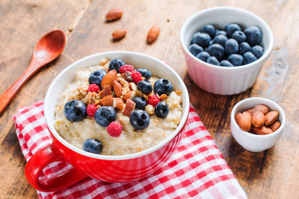 istock Oatmeal porridge with berries and nuts in a bowl 641621142