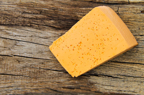 istock Piece of cheese on a wooden background 641621302