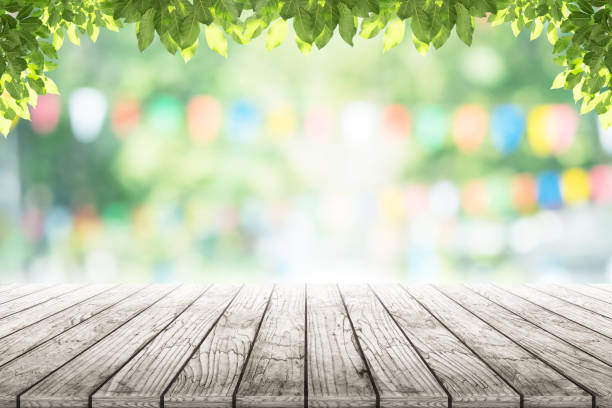 istock Empty wooden table with party in garden background blurred. 641621864