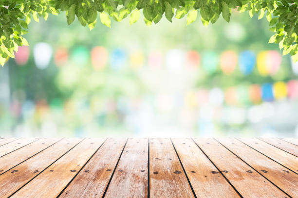 istock Empty wooden table with party in garden background blurred. 641621912