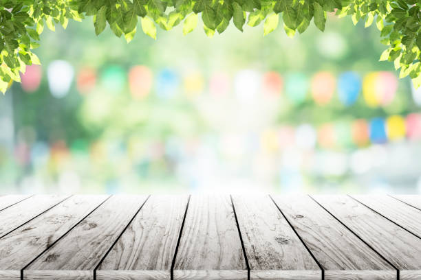 istock Empty wooden table with party in garden background blurred. 641621998