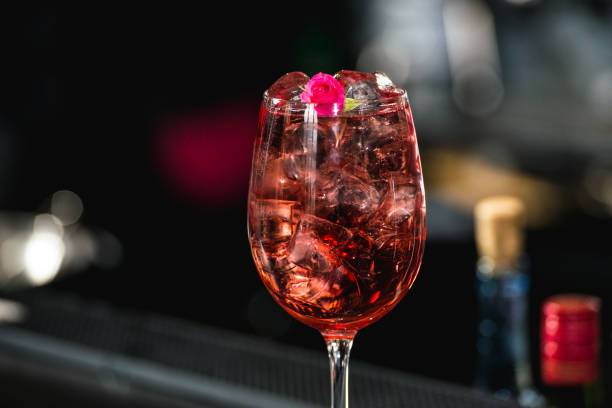 istock relaxing alcoholic pink coctail with a rose on top isolated on a bar background 641622196