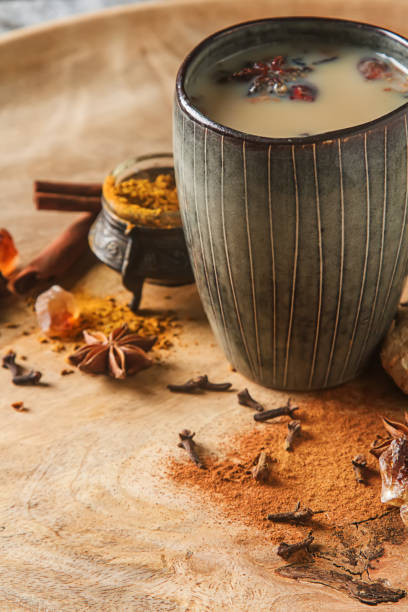 istock Traditional Indian masala tea in ceramic cup with spices to milk 641622416