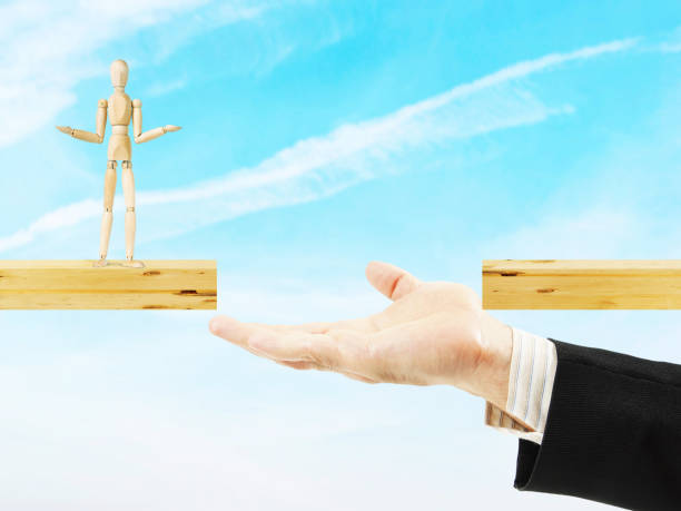 istock Man helps other to cross the chasm 641622858