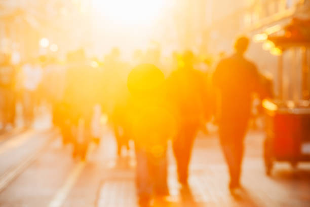 Crowded pedestrian walking on Istiklal street on sunny day with sunflare in Taksim, Beyoğlu, Istanbul, Turkey. Blur Motion