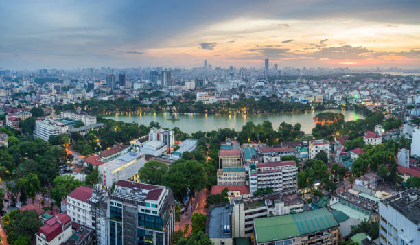 Aerial skyline view of Hoan Kiem lake (Ho Guom, Sword lake) area at twilight. Hoan Kiem is center of Hanoi city. Hanoi cityscape Aerial skyline view of Hoan Kiem lake (Ho Guom, Sword lake) area at twilight. Hoan Kiem is center of Hanoi city. Hanoi cityscape. ho guom stock pictures, royalty-free photos & images
