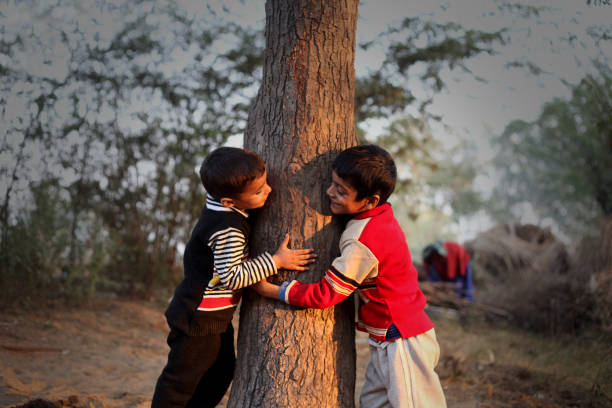 poor children playing and climbing tree