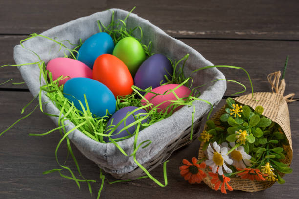 istock Easter basket with colored eggs and bunch of spring flowers. 641633272