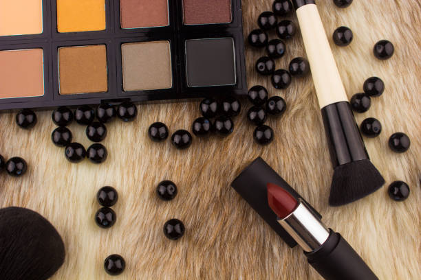 istock Makeup tools on Fur background / featuring eyeshadow palette, lipstick, makeup brushes on a fury background 641637408