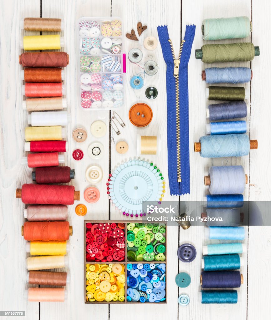 Tools for sewing on light wooden background. Top view. Tools for sewing on light wooden background. Top view.  Flat lay composition. Above Stock Photo