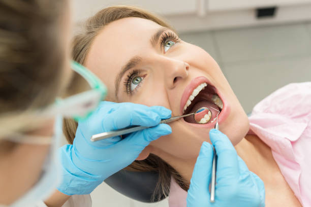 Dental hygiene Horizontal color close-up headshot of beautiful woman having dental examination. dental cavity photos stock pictures, royalty-free photos & images