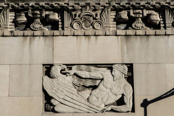 Carved relief of telephones on the Cincinnati & Suburban Telephone Building Cincinnati, Ohio, United States - June 8, 2016: carved relief of rotary telephones, a runner and bird of prey on the Cincinnati & Suburban Telephone Building. alexander graham bell stock pictures, royalty-free photos & images