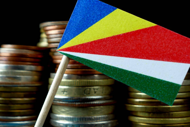istock Seychelles flag waving with stack of money coins macro 641645588