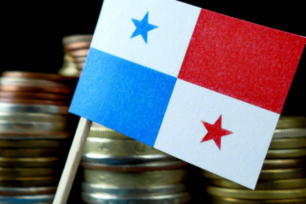 istock Panama flag waving with stack of money coins macro 641645684
