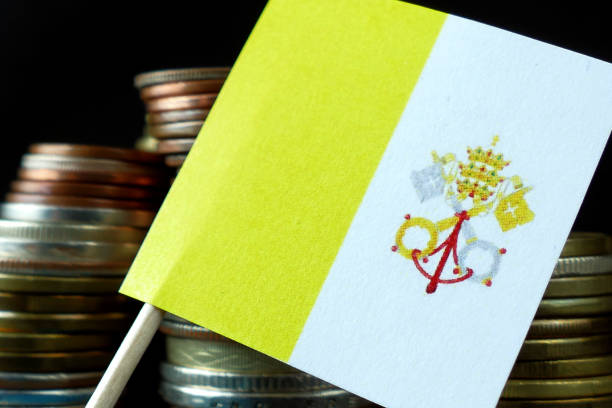 istock Vatican City flag waving with stack of money coins macro 641646628