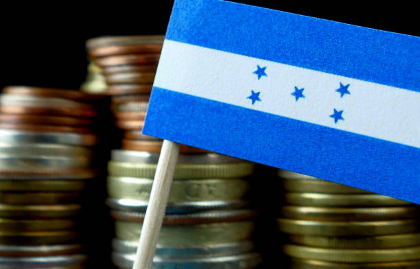 istock Honduras flag waving with stack of money coins macro 641646778