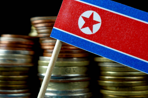 istock North Korea flag waving with stack of money coins macro 641648018
