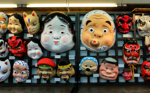 Various Type of Creative Ancient Paper Mask in Japan for Traditional Event Hanging on Wooden Wall in The Market for Sell Various Type of Creative Ancient Paper Mask in Japan for Traditional Event Hanging on Wooden Wall in The Market painted masquerade masks stock pictures, royalty-free photos & images