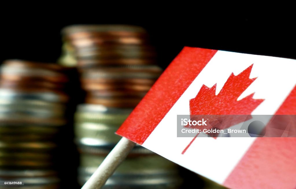 Canada flag waving with stack of money coins macro Canada Stock Photo