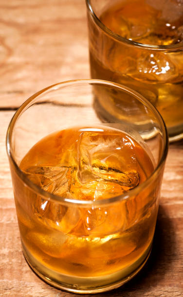 istock Whiskey on wooden background 641651198