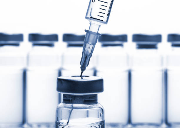istock Glass Medicine Vials and Syringe on white background 641651746