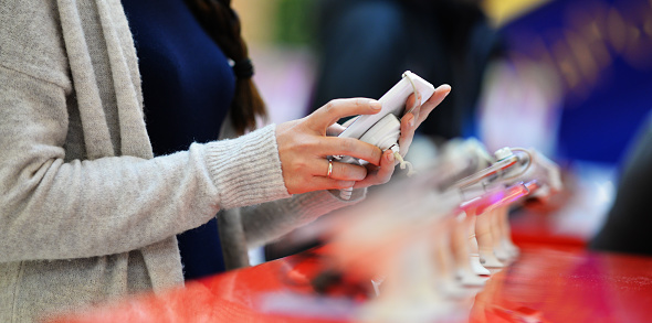 Woman looking at smartphones in store!