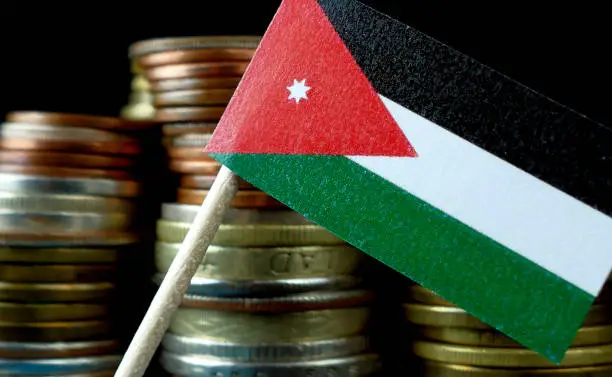 Jordan flag waving with stack of money coins macro